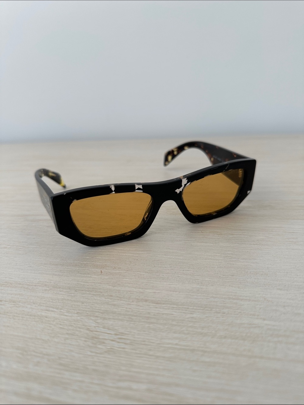 Prada Black Frame Sunglasses with Amber Lenses